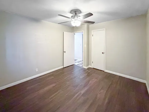 a view of an empty room with wooden floor