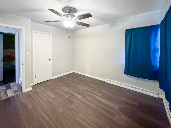a view of a roof deck with table and chairs with wooden floor and fence