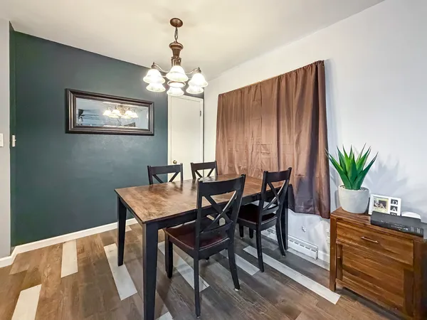 a view of a dining room with furniture and chandelier