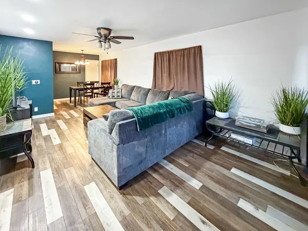 a living room with furniture and a potted plant