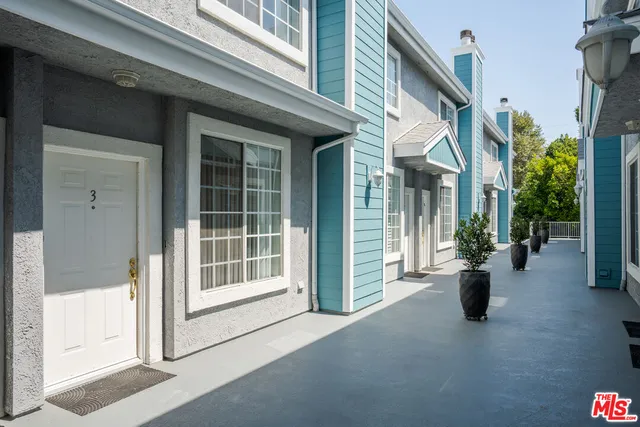 a view of a building with potted plant windows