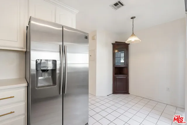 a kitchen with kitchen island a counter top space and refrigerator