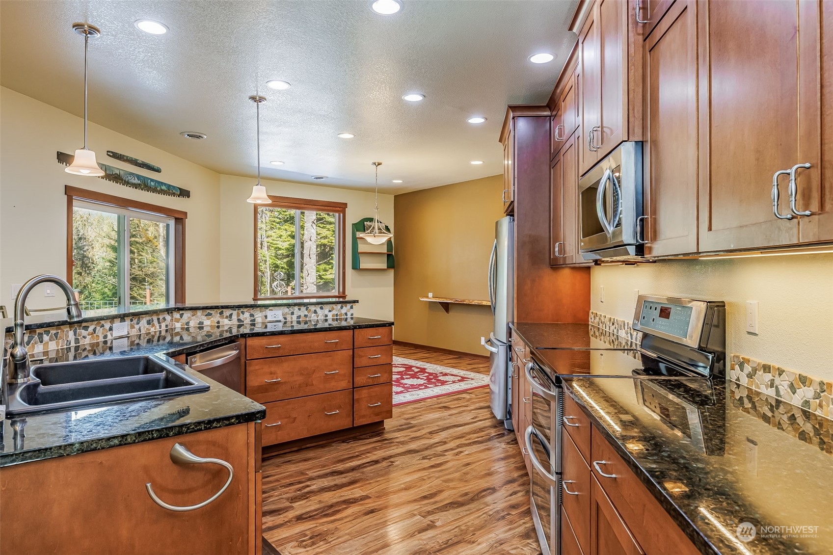 119 Marmot Loop Packwood, WA 98361 - Photo 13 of 40 a kitchen with wooden cabinets and a sink