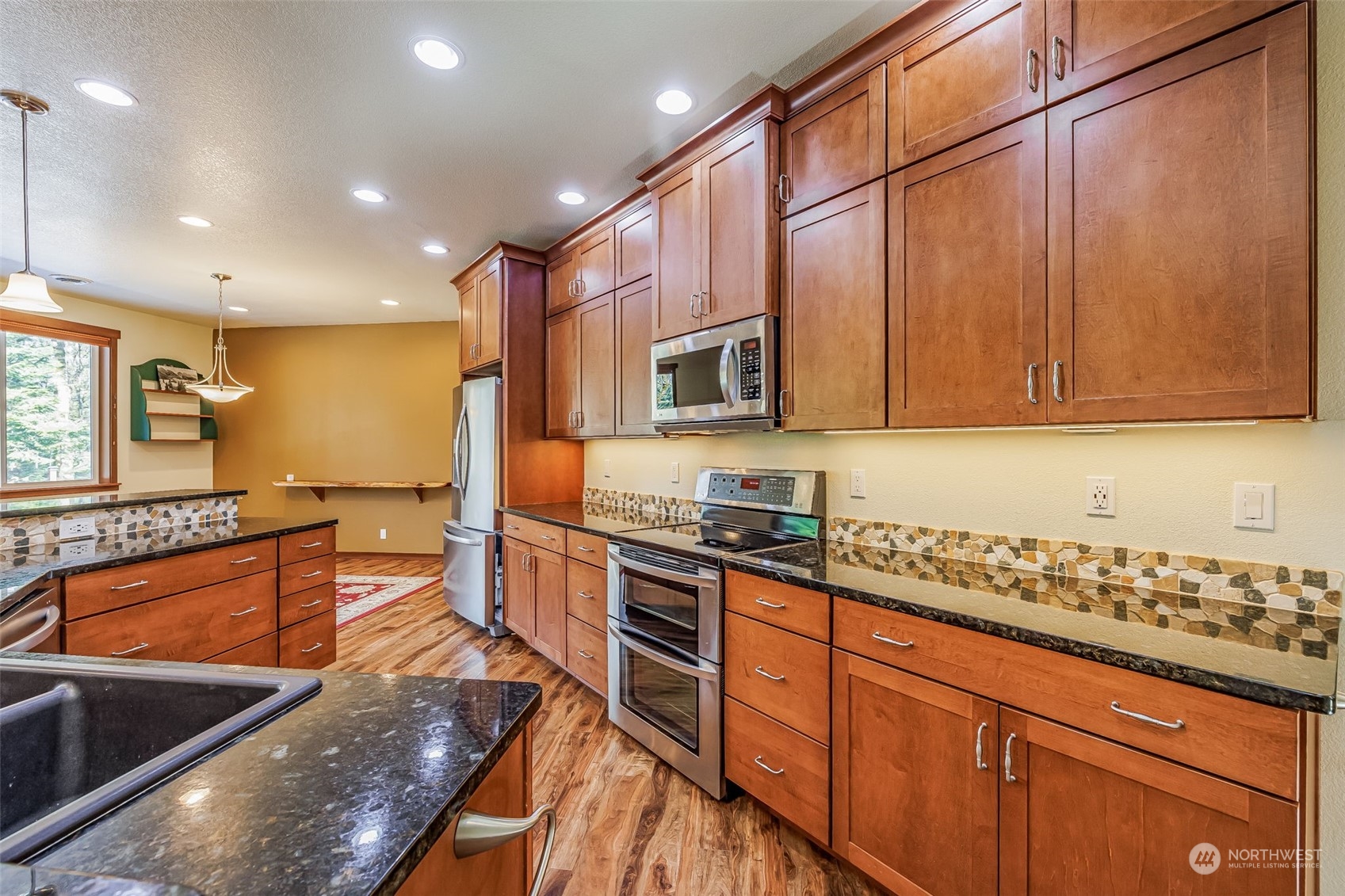 119 Marmot Loop Packwood, WA 98361 - Photo 14 of 40 a kitchen with stainless steel appliances granite countertop a sink and cabinets