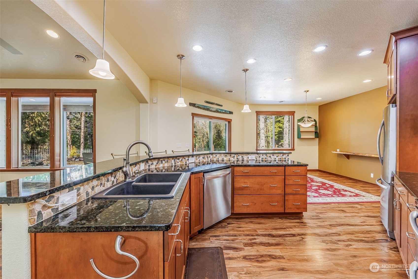 119 Marmot Loop Packwood, WA 98361 - Photo 15 of 40 a kitchen with stainless steel appliances granite countertop a sink a stove and a refrigerator