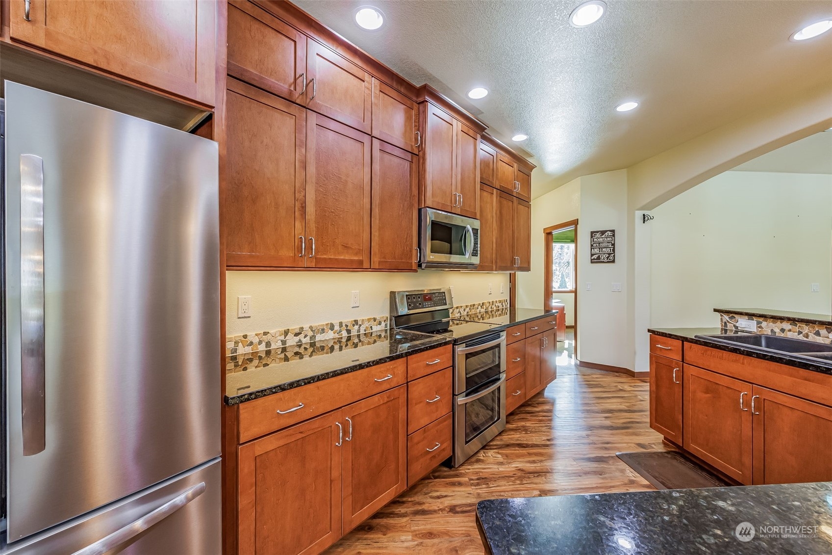 119 Marmot Loop Packwood, WA 98361 - Photo 16 of 40 a kitchen with stainless steel appliances granite countertop a refrigerator a stove top oven a sink and dishwasher