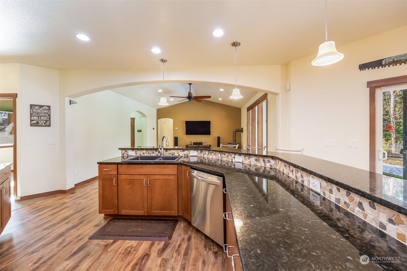 119 Marmot Loop Packwood, WA 98361 - Photo 17 of 40 a view of a large kitchen with sink and dishwasher with wooden floor