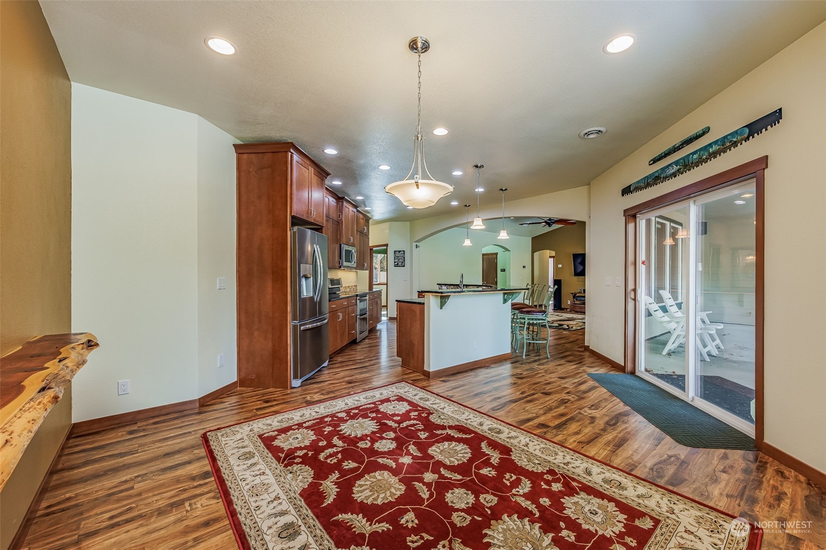 119 Marmot Loop Packwood, WA 98361 - Photo 19 of 40 a living room with a rug kitchen view and a chandelier