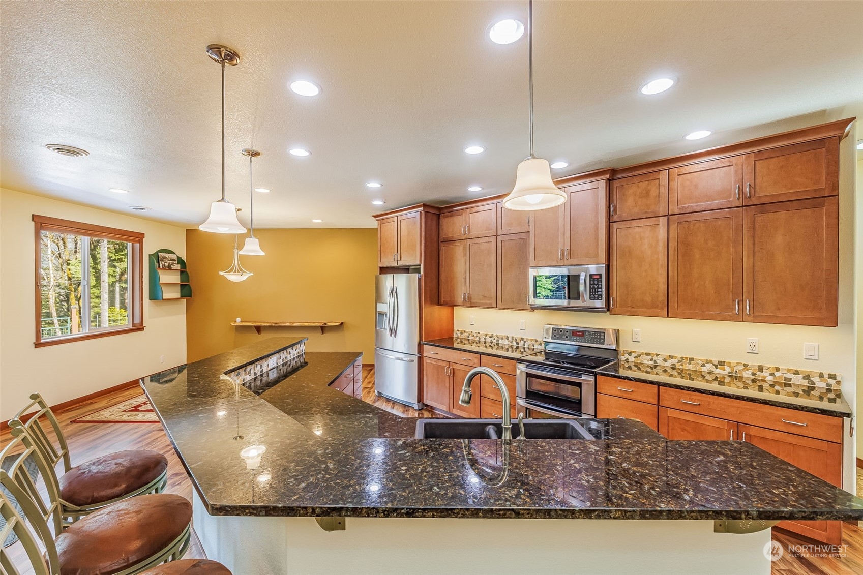 119 Marmot Loop Packwood, WA 98361 - Photo 22 of 40 a kitchen with kitchen island granite countertop a stove and a sink