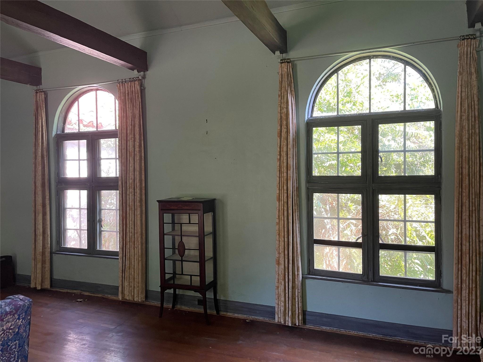 85 Melrose Avenue Tryon, NC 28782 - Photo 7 of 22 an empty room with wooden floor windows and outdoor view