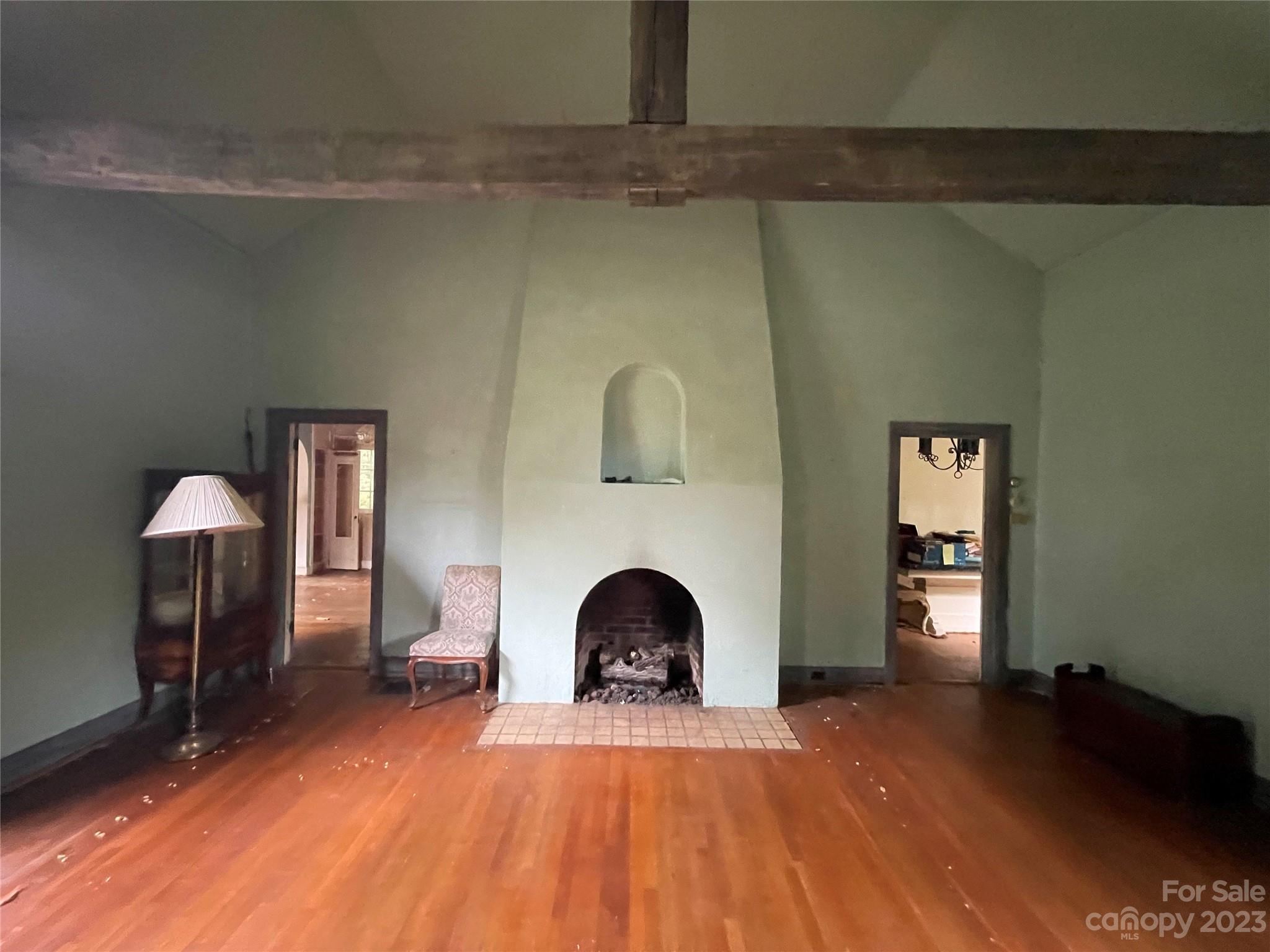85 Melrose Avenue Tryon, NC 28782 - Photo 8 of 22 a view of a livingroom with wooden floor and a fireplace