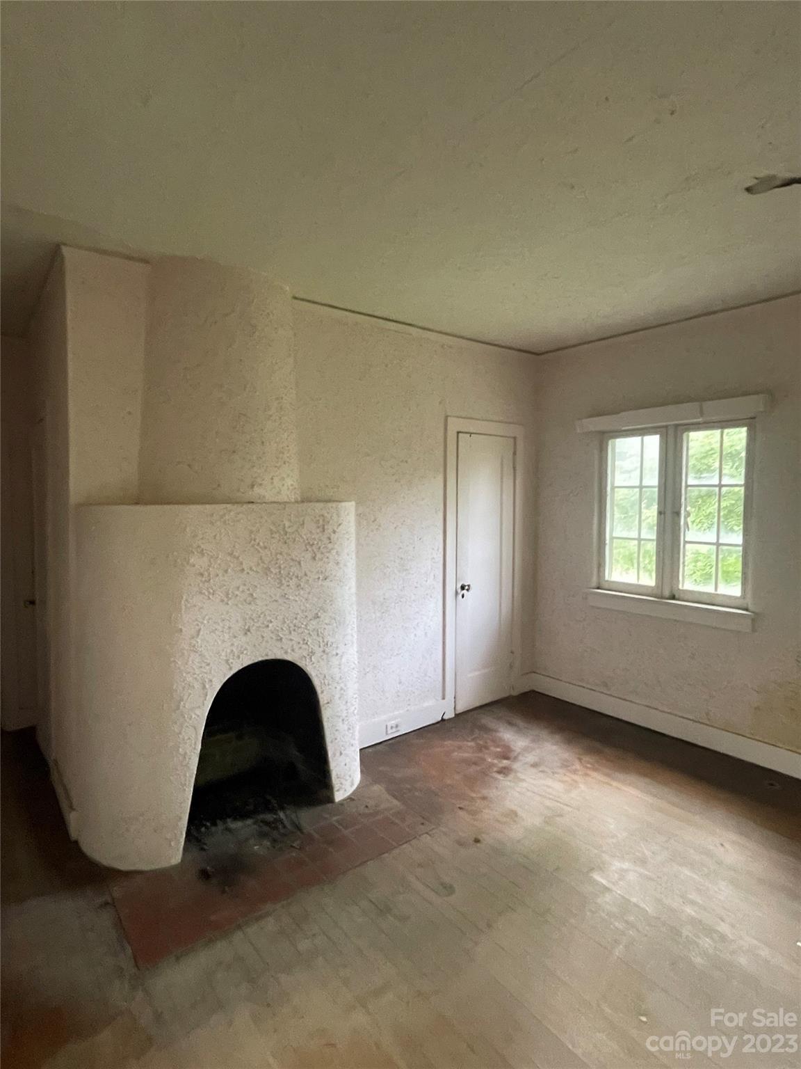 85 Melrose Avenue Tryon, NC 28782 - Photo 9 of 22 a view of empty room with fireplace
