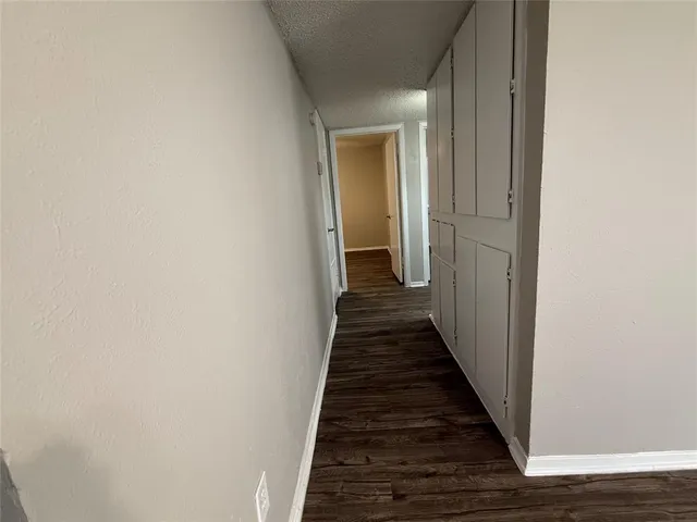 a view of a hallway with a wooden floor