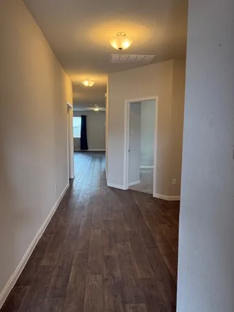 a view of a room with wooden floor and a window