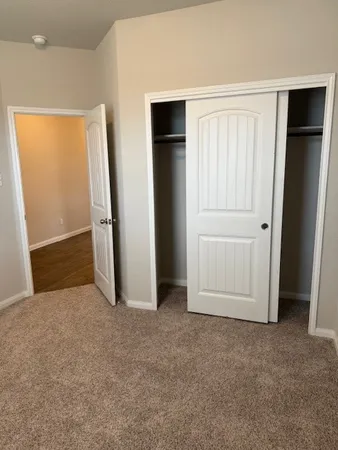 an empty room with closet area