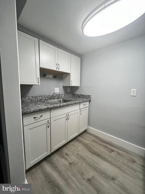 547 4th Street Southeast Washington, DC 20003 - Photo 8 of 12 a kitchen with granite countertop white cabinets and white appliances
