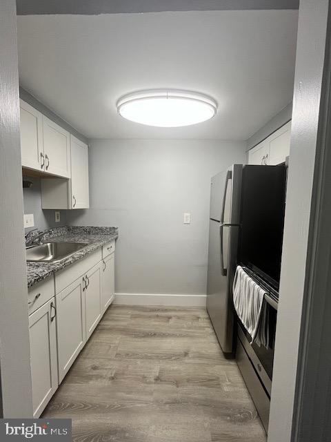 547 4th Street Southeast Washington, DC 20003 - Photo 9 of 12 a kitchen with granite countertop a refrigerator a sink a stove a washer dryer and a refrigerator