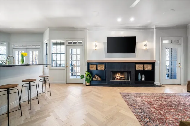 a bedroom with a large bed chandelier and a window