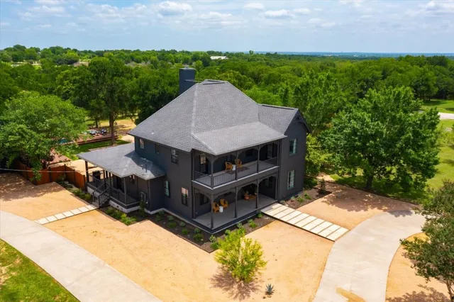an aerial view of a house with yard and outdoor seating
