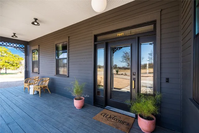 a view of a a dining room and livingroom with furniture wooden floor a chandelier