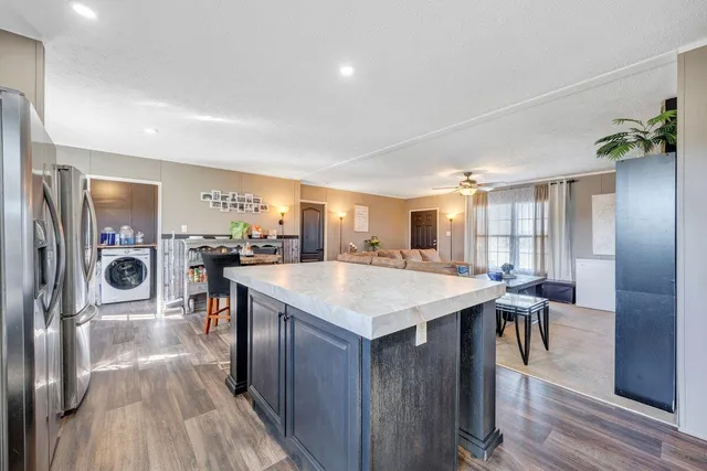 a large kitchen with a table and chairs
