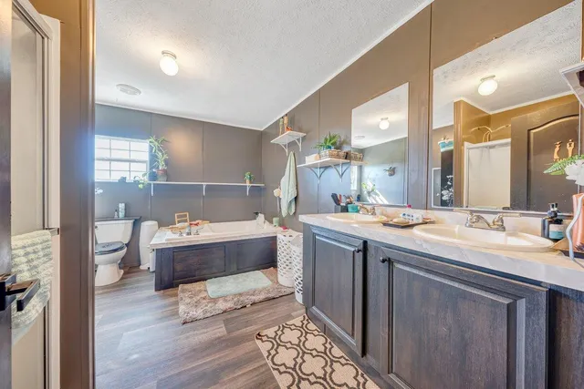 a large bathroom with a large tub and sink