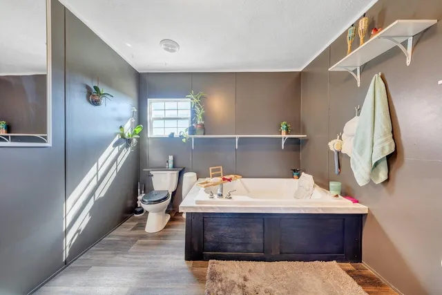 a bathroom with a sink and mirror with bathtub