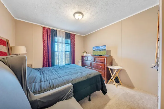 a bed room with a bed and a chair