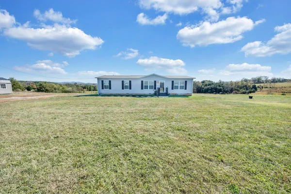 a view of a large pool with an outdoor space and seating area