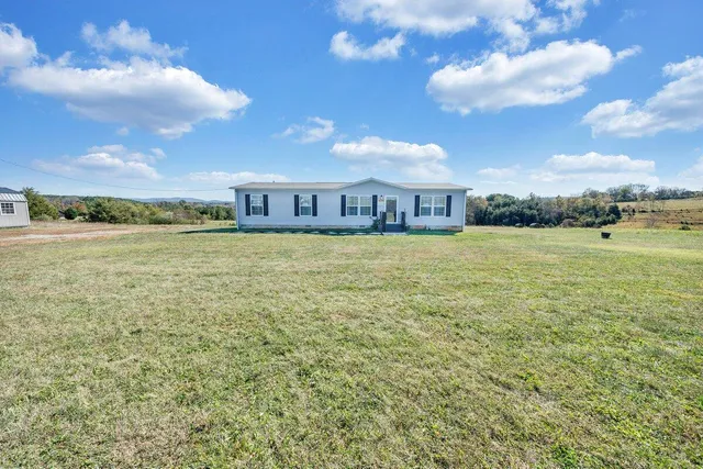 a view of a large pool with an outdoor space and seating area