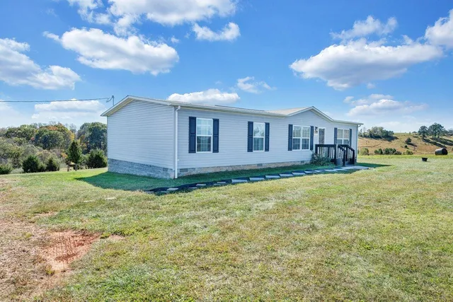 a view of a house with a backyard