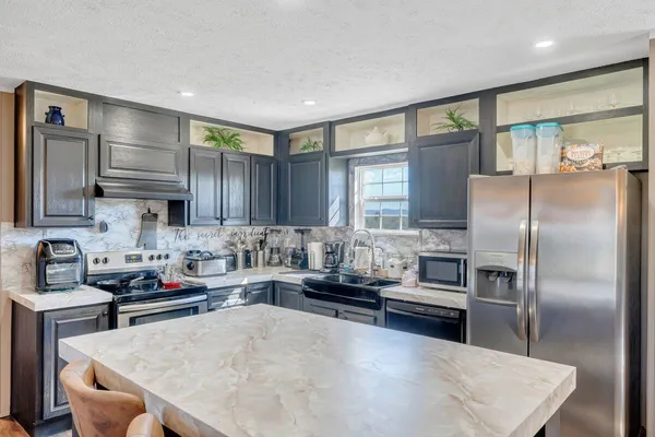 a kitchen with a refrigerator a sink and cabinets