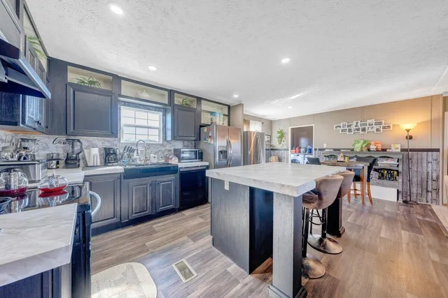 a kitchen with a sink a counter top space and appliances