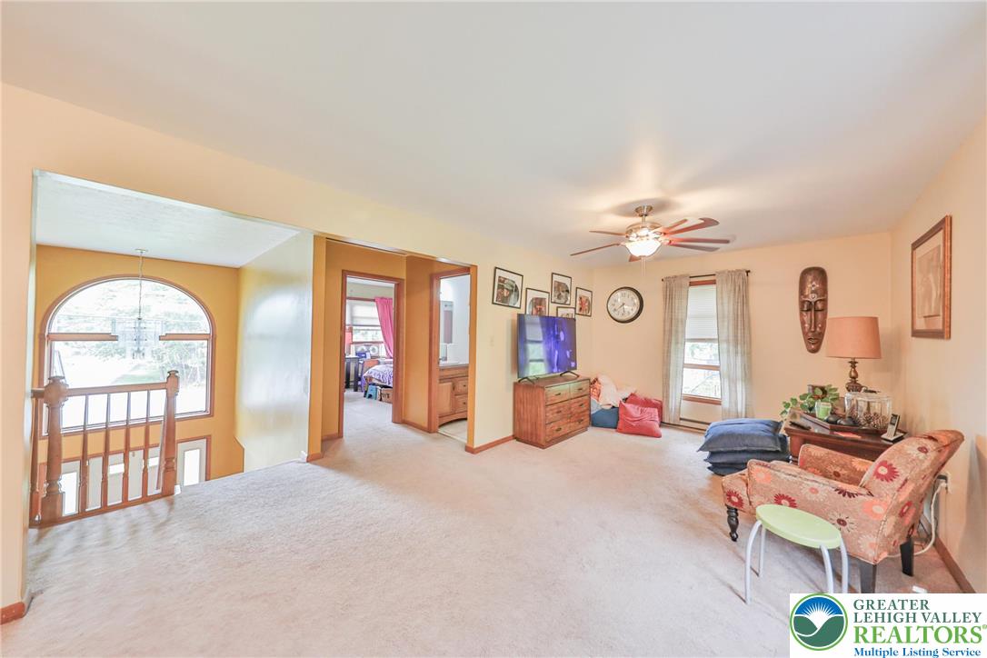 4608 Pine Ridge Drive West Bushkill, PA 18324 - Photo 12 of 62 A comfortable living space features a large arched window and inviting natural light.
