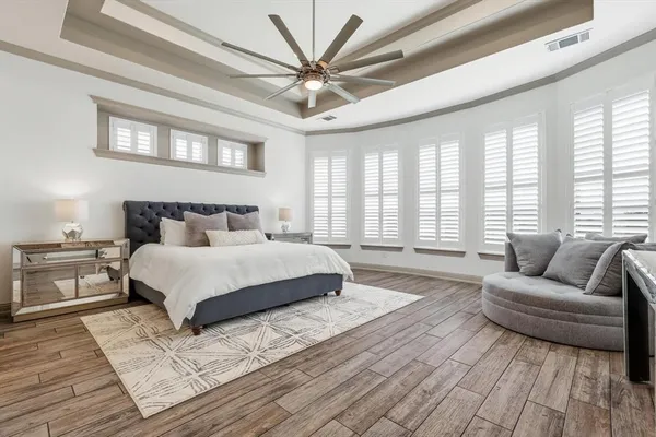 a bedroom with a large bed and a couch