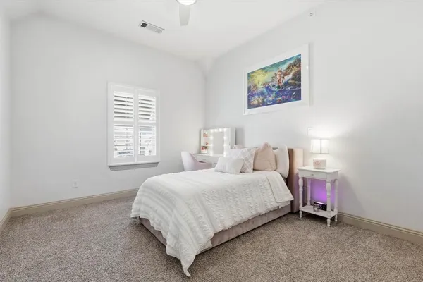 a spacious bedroom with a bed and a window