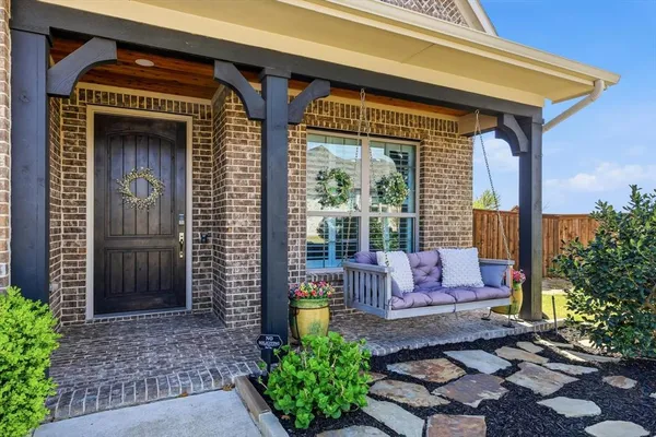 a front view of a house with outdoor seating and plants