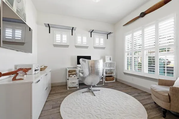 a room with furniture a large window and a chandelier