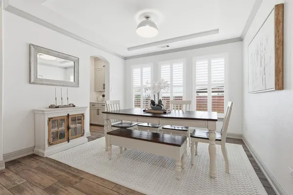 a kitchen with stainless steel appliances a stove a sink and white cabinets