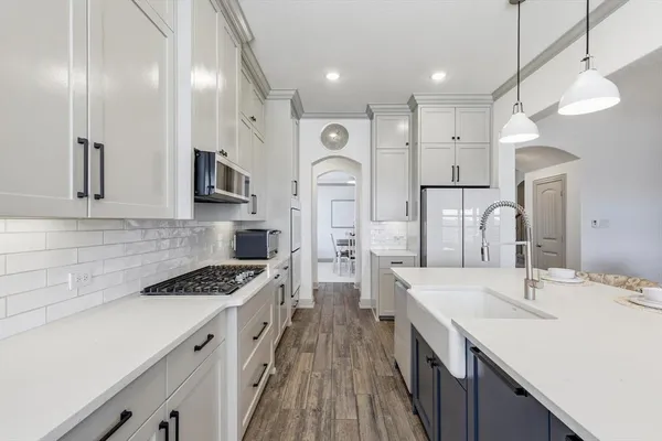 a kitchen with cabinets and wooden floor