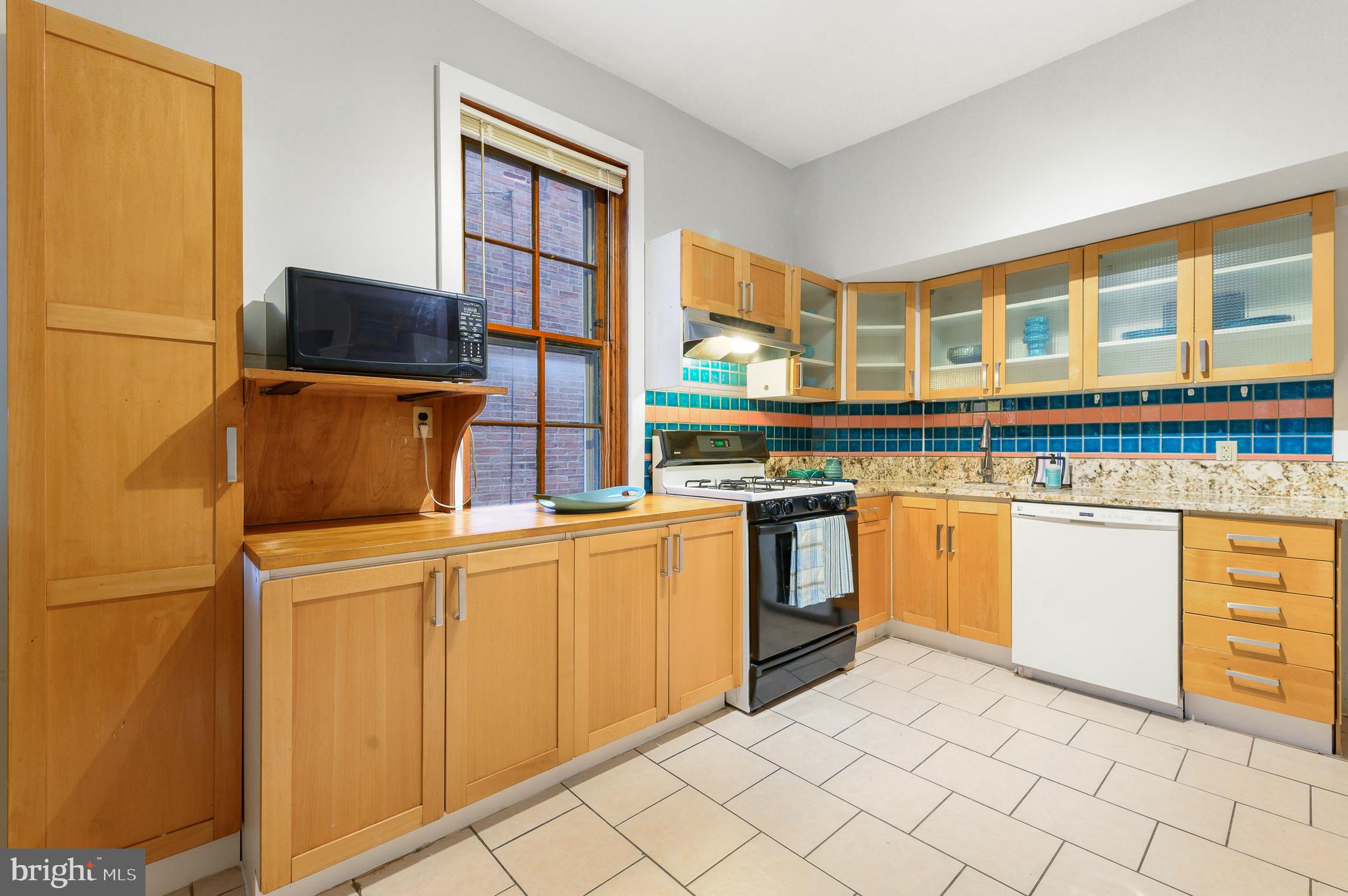 4248 Regent Square Philadelphia, PA 19104 - Photo 12 of 32 a kitchen with cabinets and chairs