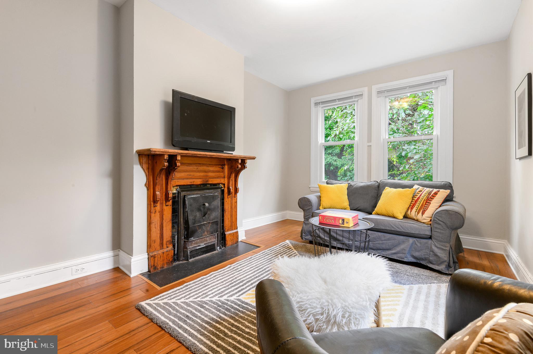 4248 Regent Square Philadelphia, PA 19104 - Photo 19 of 32 a living room with furniture a flat screen tv and a fireplace