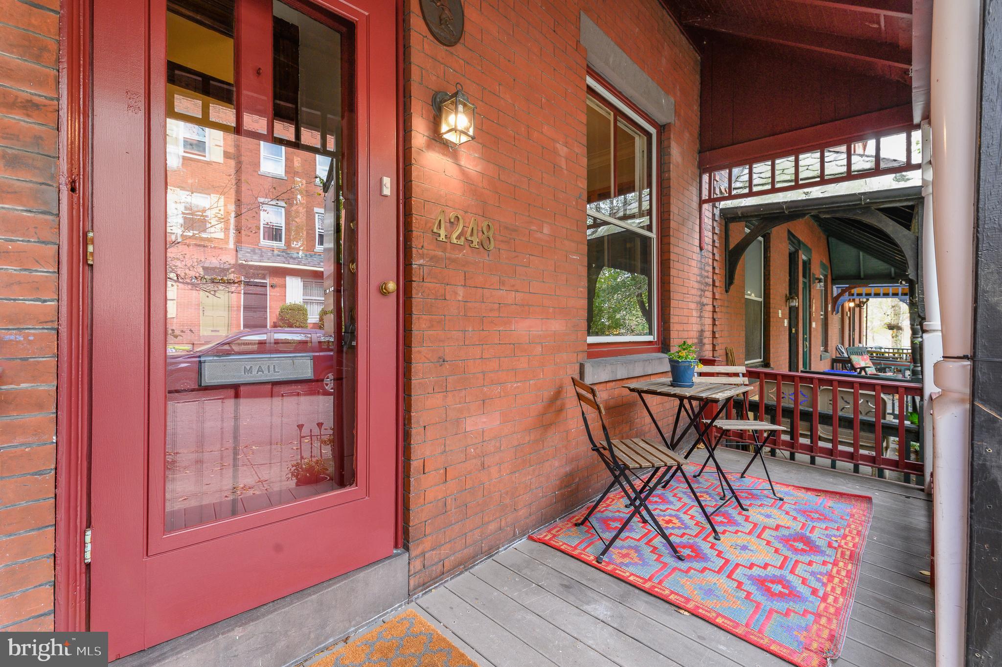 4248 Regent Square Philadelphia, PA 19104 - Photo 3 of 32 a view of a brick building with a bench and glass door