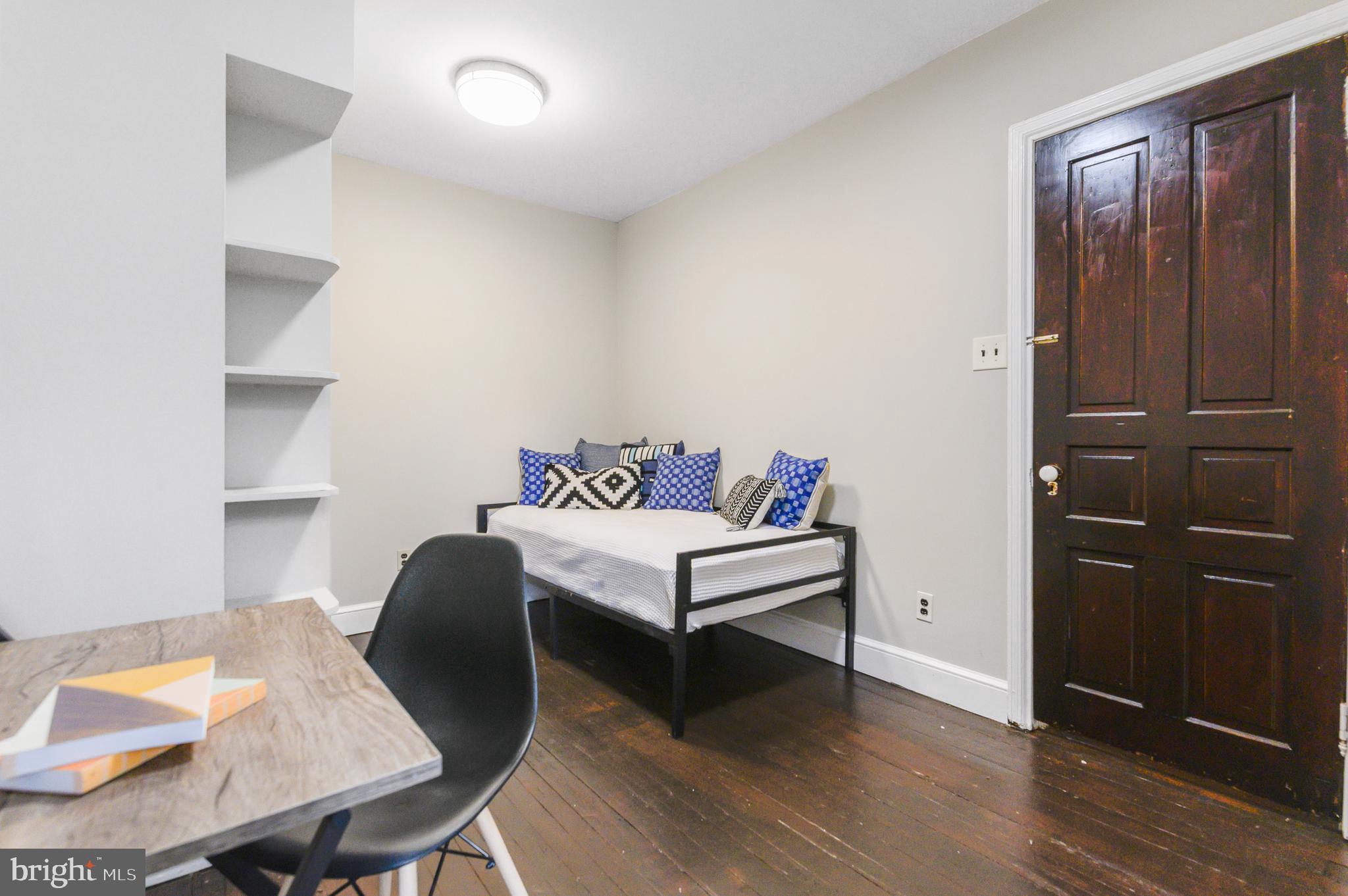 4248 Regent Square Philadelphia, PA 19104 - Photo 29 of 32 a bedroom with a bed and a table in it