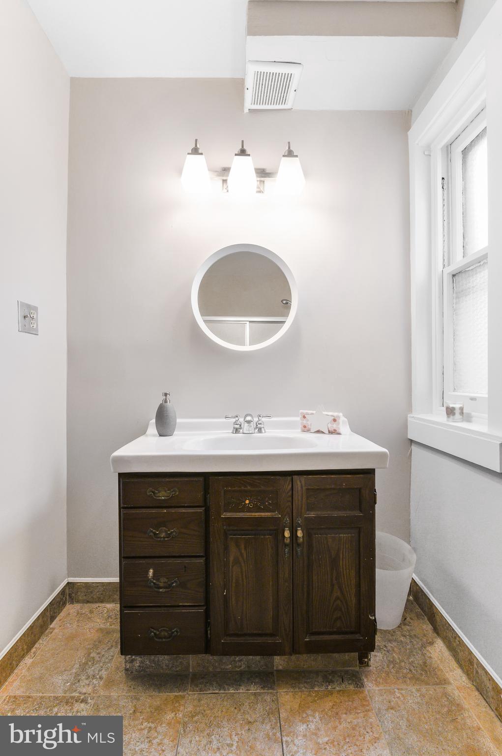4248 Regent Square Philadelphia, PA 19104 - Photo 31 of 32 a bathroom with a sink and a mirror