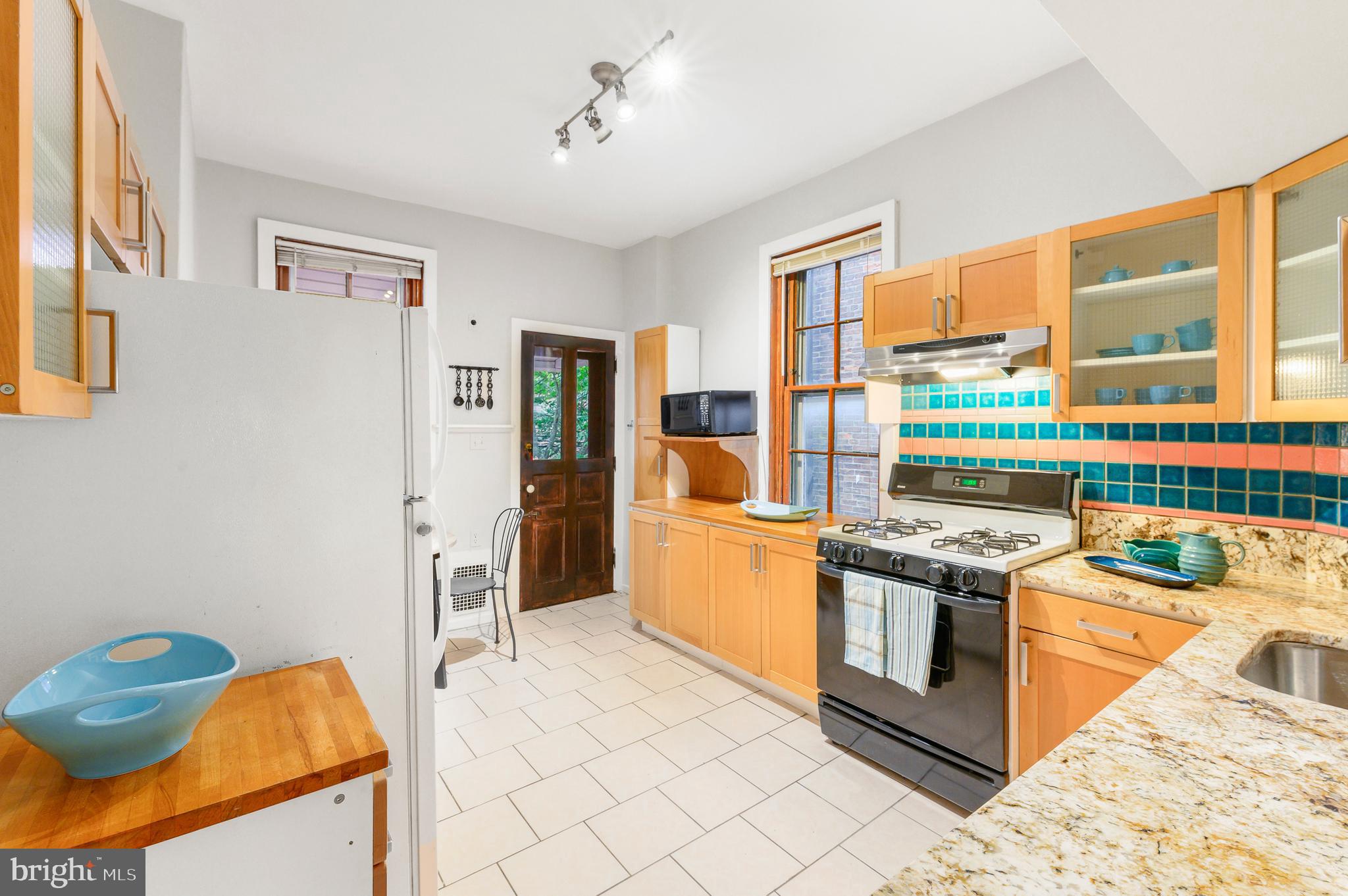 4248 Regent Square Philadelphia, PA 19104 - Photo 7 of 32 a kitchen with stainless steel appliances granite countertop a stove and a sink