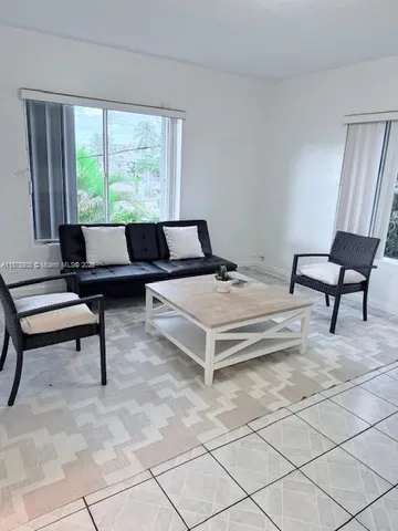 a living room with furniture and a window