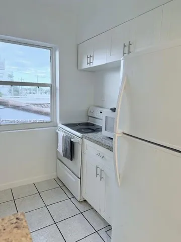 a kitchen with a stove and a refrigerator