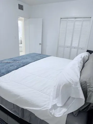 a bedroom with a bed and a mirror