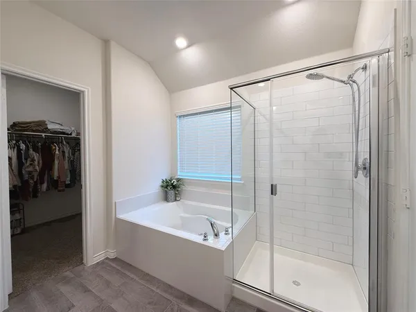 a bathroom with a bathtub and a shower